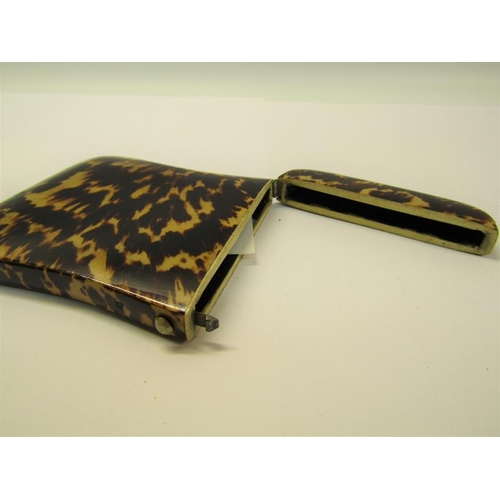 76 - A Victorian tortoiseshell visiting card case with ivory rims and being of waisted form, 8cm x 10cm.