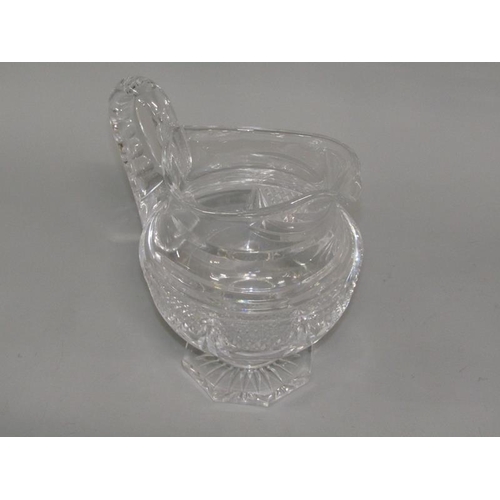 249 - An early 19c English cut glass jug with diamond cut and swag decoration, scrolling handle, supported... 