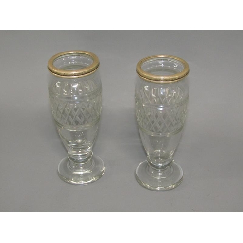 253 - A pair of 19c cut glass vases of baluster form with silver upper rims and supported on circular base... 