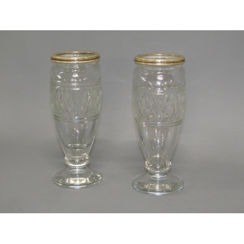 253 - A pair of 19c cut glass vases of baluster form with silver upper rims and supported on circular base... 