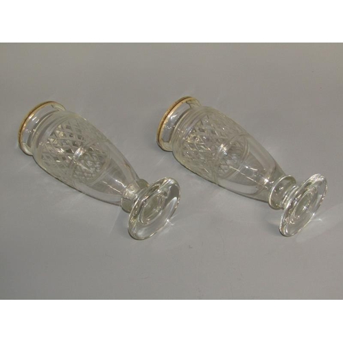 253 - A pair of 19c cut glass vases of baluster form with silver upper rims and supported on circular base... 