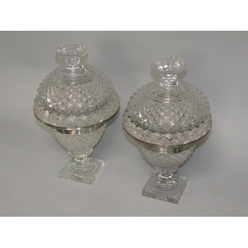 256 - A pair of early 19c cut glass bonbonnieres with lift off covers, having cut finials, the bowls with ... 