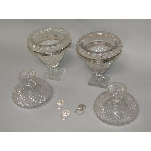 256 - A pair of early 19c cut glass bonbonnieres with lift off covers, having cut finials, the bowls with ... 