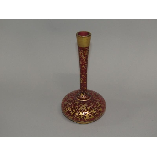 259 - A Victorian ruby glass specimen vase with a squat baluster body, tall slender neck, gilt decorated, ... 