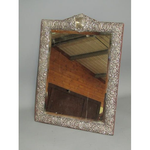 240 - A late Victorian silver easel dressing table mirror within a pierced scroll and floral border with a... 