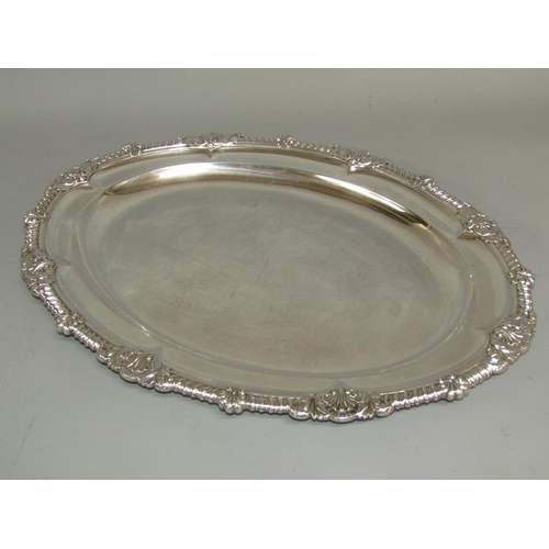 241 - A pair of late Georgian silver platters of oval form with raised and cast borders with gadroon, shel... 