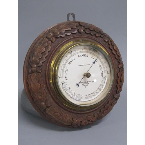 13 - An early 20c aneroid barometer by Negretti & Zambra in circular hardwood case carved with oak leaves... 