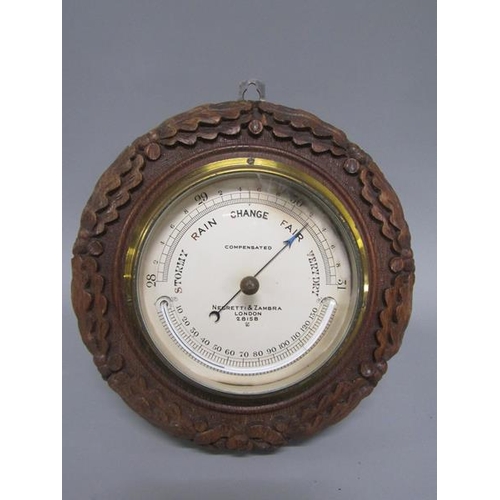 13 - An early 20c aneroid barometer by Negretti & Zambra in circular hardwood case carved with oak leaves... 