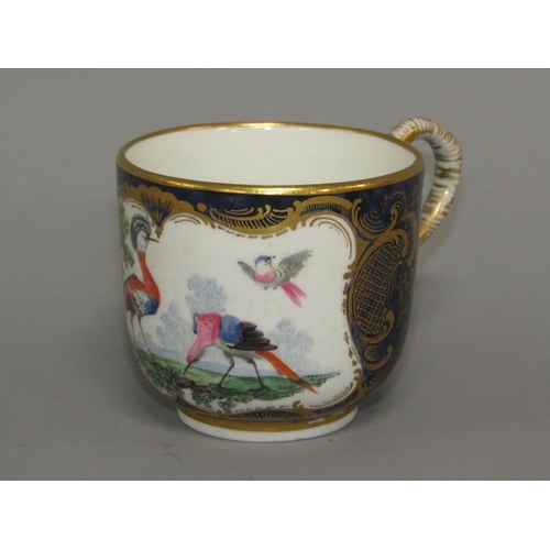 274 - A First period Worcester cup and saucer of scale blue ground painted with exotic birds within ornate... 