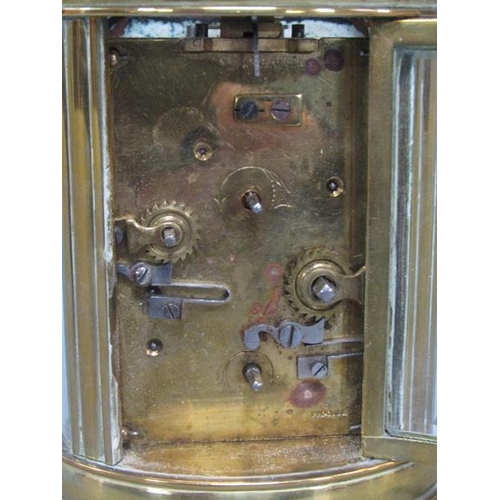 6 - A late 19c French carriage clock in glazed brass oval case.  The single train movement has a cylinde... 