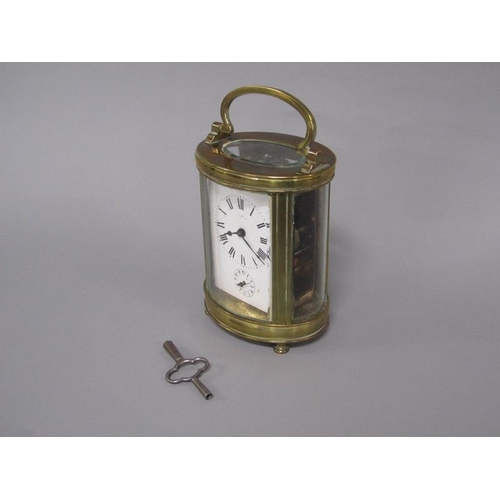 6 - A late 19c French carriage clock in glazed brass oval case.  The single train movement has a cylinde... 