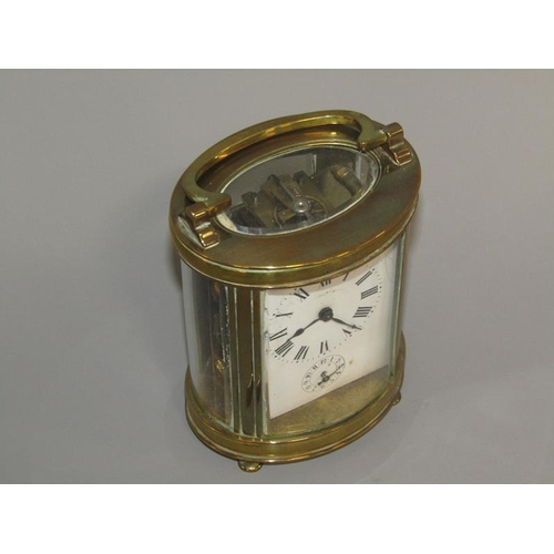 6 - A late 19c French carriage clock in glazed brass oval case.  The single train movement has a cylinde... 