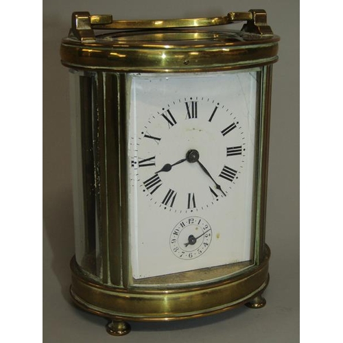 6 - A late 19c French carriage clock in glazed brass oval case.  The single train movement has a cylinde... 