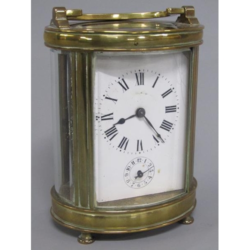 6 - A late 19c French carriage clock in glazed brass oval case.  The single train movement has a cylinde... 