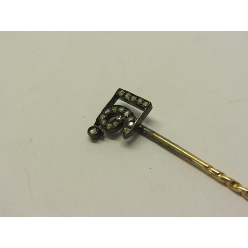 149 - An early 20c gold stick pin with a diamond set terminal - 16, 6cm l.