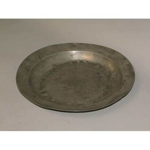 25 - A 17c/early 18c pewter dish with touch marks to rear, with crowned rose over the touch of brown and ... 