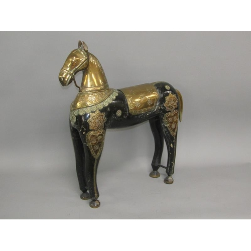 43 - A 19c Oriental model of a horse, black lacquered carved wood with brass head and harness, 70cm h, 64... 