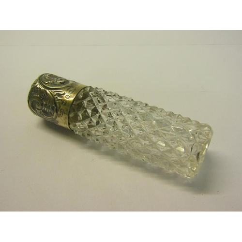 79 - Two late Victorian clear glass scent bottles, both diamond cut and one of tapering form, with hinged... 