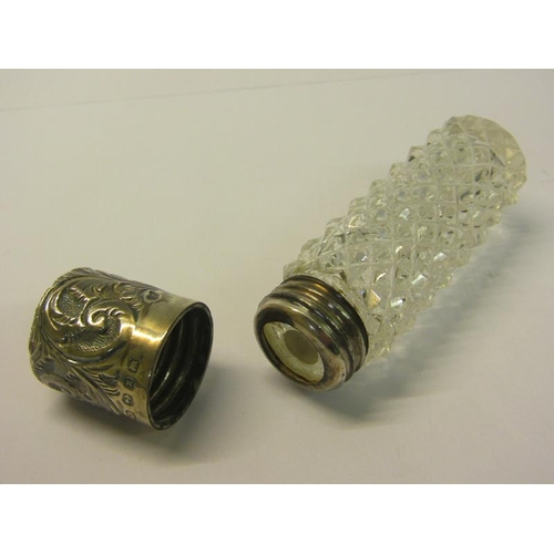 79 - Two late Victorian clear glass scent bottles, both diamond cut and one of tapering form, with hinged... 