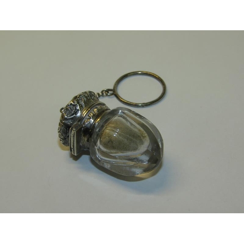 80 - A Victorian cut glass vinaigrette with embossed and chased silver grill and mount, together with a h... 