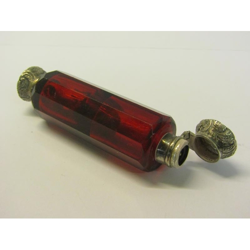 82 - A collection of three late 19c/early 20c cut ruby glass double ended scent bottles with silver embos... 