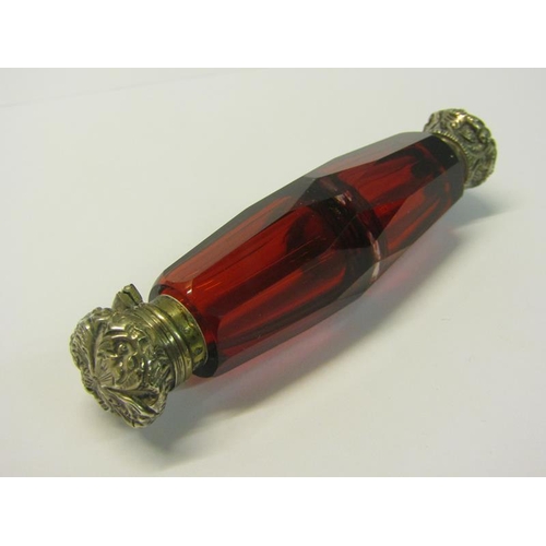 82 - A collection of three late 19c/early 20c cut ruby glass double ended scent bottles with silver embos... 