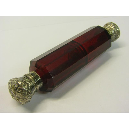 82 - A collection of three late 19c/early 20c cut ruby glass double ended scent bottles with silver embos... 