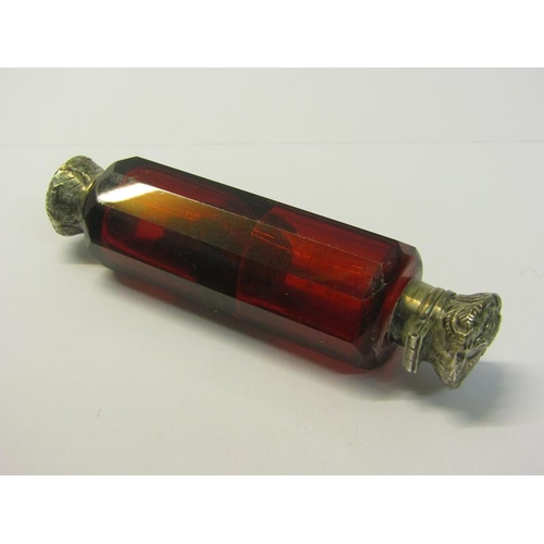 82 - A collection of three late 19c/early 20c cut ruby glass double ended scent bottles with silver embos... 