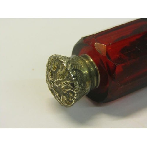 82 - A collection of three late 19c/early 20c cut ruby glass double ended scent bottles with silver embos... 