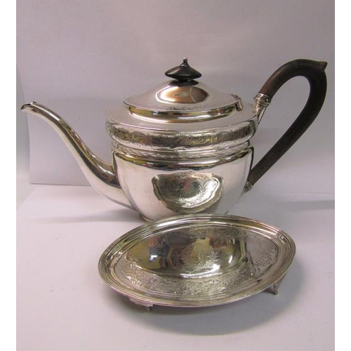 238 - A George III silver teapot of oval form, chased with bands of leaf and flowers, having a composite h... 