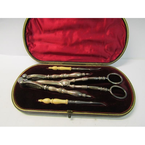 244 - A late 19c boxed set of silver plated nut cracks, a pair of grape scissors and a pair of bone handle... 