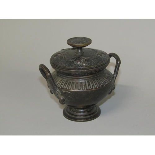 17 - A late 19c Continental patinated bronze two handled bowl of urn form with hinged cover, 9.5cm h.