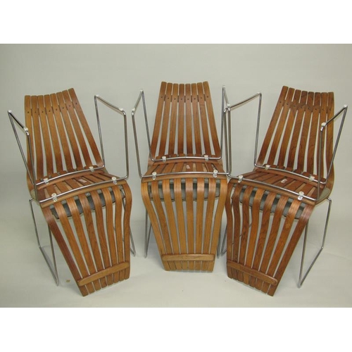 454 - A set of six Norwegian dining chairs of slatted design with metal legs and under frames, designed by... 