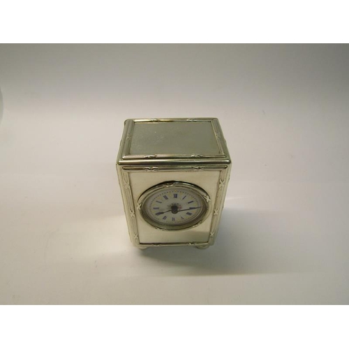 189 - A late Edwardian silver cased mantel clock with a French movement and having a white enamel decorate... 