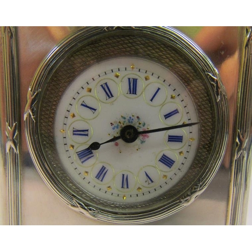 189 - A late Edwardian silver cased mantel clock with a French movement and having a white enamel decorate... 