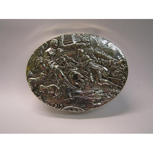 195 - A late Victorian silver ladies box of oval form, the hinged cover embossed and chased with a scene o... 