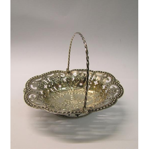 197 - A mid Georgian silver basket of pierced and embossed oval form with a rope twist swing handle, maker... 