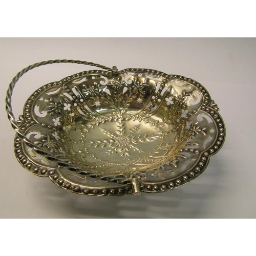 197 - A mid Georgian silver basket of pierced and embossed oval form with a rope twist swing handle, maker... 