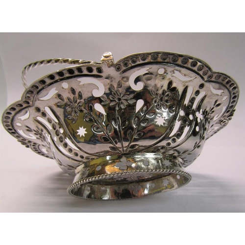 197 - A mid Georgian silver basket of pierced and embossed oval form with a rope twist swing handle, maker... 