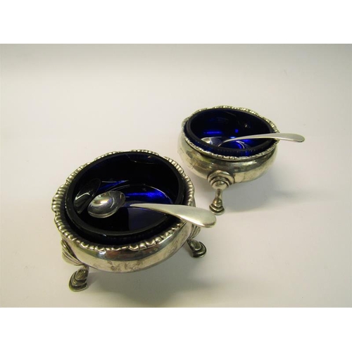 205 - A pair of silver salt cellars, London 1764 & 1774, with later spoons, each 6cm diam.