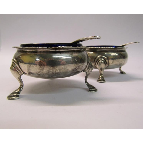 205 - A pair of silver salt cellars, London 1764 & 1774, with later spoons, each 6cm diam.