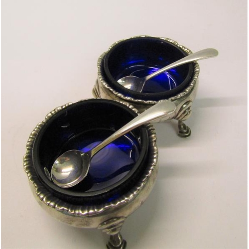 205 - A pair of silver salt cellars, London 1764 & 1774, with later spoons, each 6cm diam.