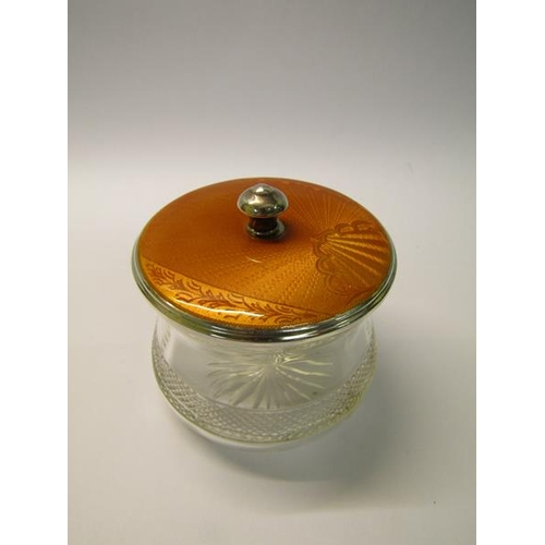 208 - An Art Deco period cut glass powder pot with a silver and enamel lift off cover, makers mark for Adi... 