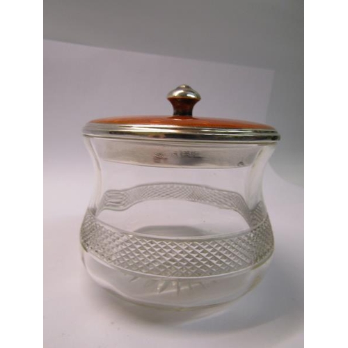 208 - An Art Deco period cut glass powder pot with a silver and enamel lift off cover, makers mark for Adi... 