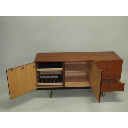 451 - A 1970's Stag teak sideboard fitted four short drawers and cupboard with fitted pull out cutlery tra... 