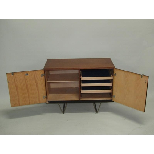 452 - A 1970's Stag teak dining room cabinet, fitted with three pull out linen shelves and one shelved cup... 