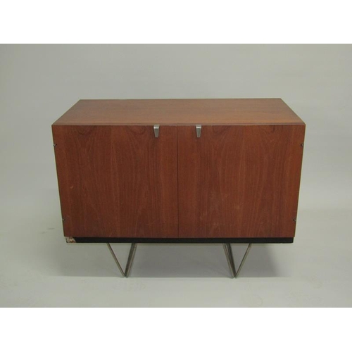 452 - A 1970's Stag teak dining room cabinet, fitted with three pull out linen shelves and one shelved cup... 