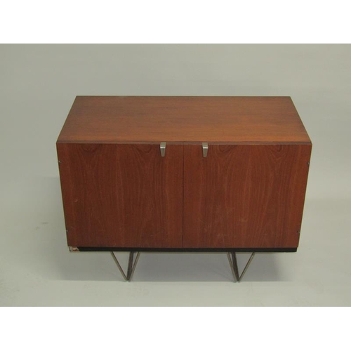 452 - A 1970's Stag teak dining room cabinet, fitted with three pull out linen shelves and one shelved cup... 