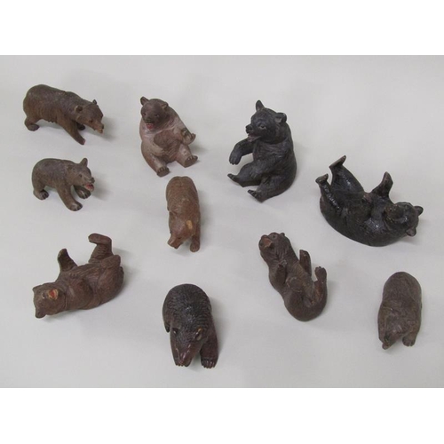 45 - A collection of ten late 19c/early 20c Black Forest carved wood bears of differing sizes and poses, ... 