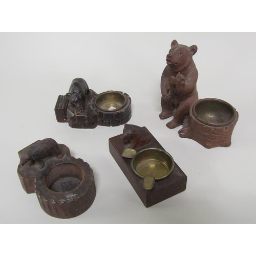 47 - A collection of four early 20c Black Forest carved wood bear mounted ashtrays with matchbox holders ... 